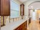 Kitchen with wooden cabinets, tiled backsplash, and natural lighting from the window at 13055 Overstreet Rd, Windermere, FL 34786