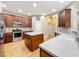 Kitchen with wood cabinets, stainless steel appliances, light countertops, and center island at 13055 Overstreet Rd, Windermere, FL 34786