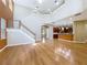 Open living room features a staircase, hardwood floors, and access to the kitchen at 13055 Overstreet Rd, Windermere, FL 34786