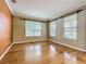 Cozy room featuring hardwood floors, large windows, and neutral-toned walls at 13055 Overstreet Rd, Windermere, FL 34786