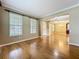 Bright living room featuring hardwood floors, high ceilings, and large windows providing natural light at 13055 Overstreet Rd, Windermere, FL 34786