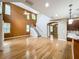 Open living room features a vaulted ceiling, staircase, hardwood floors, and large windows at 13055 Overstreet Rd, Windermere, FL 34786