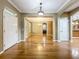 Open living room with hardwood floors and ample natural light from multiple windows at 13055 Overstreet Rd, Windermere, FL 34786