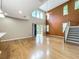 Open living room features a vaulted ceiling, large windows, hardwood floors, and sliding glass doors at 13055 Overstreet Rd, Windermere, FL 34786