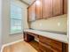 Home office with built-in desk, cabinets, and a large window for natural light at 13055 Overstreet Rd, Windermere, FL 34786