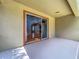 View from covered patio into the bright living room area, providing seamless transition between inside/outside at 13055 Overstreet Rd, Windermere, FL 34786