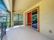 Large covered patio with views of the lake, lush backyard and living space at 13055 Overstreet Rd, Windermere, FL 34786