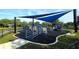 A modern playground featuring a sunshade, accessible ramps, and colorful play equipment for children of all abilities at 13055 Overstreet Rd, Windermere, FL 34786