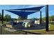 Colorful playground area with a shade covering, benches and multiple play structures for children to enjoy the outdoors at 13055 Overstreet Rd, Windermere, FL 34786