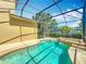 Relaxing private swimming pool surrounded by beautiful greenery and complete with spillover spa at 13055 Overstreet Rd, Windermere, FL 34786