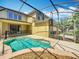 View of the screened in pool area of the home, backyard and upstairs living area at 13055 Overstreet Rd, Windermere, FL 34786