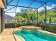 Screened in pool with spillover spa, patio and well manicured landscaping at 13055 Overstreet Rd, Windermere, FL 34786