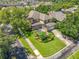 Backyard featuring a screened-in pool, lush landscaping, and an expansive lawn at 13055 Overstreet Rd, Windermere, FL 34786