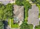 Aerial view of the home highlighting the screened-in pool and surrounding greenery at 13055 Overstreet Rd, Windermere, FL 34786
