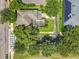 Aerial view showcasing the screened-in pool, lush landscaping, and proximity to the street at 13055 Overstreet Rd, Windermere, FL 34786