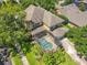 Backyard featuring a screened-in pool, lush landscaping, and an expansive lawn at 13055 Overstreet Rd, Windermere, FL 34786