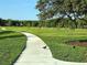 Scenic walking path through a green park, ideal for a leisurely stroll or morning jog with lush scenery at 13055 Overstreet Rd, Windermere, FL 34786