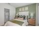 Inviting bedroom with a walk-in closet, a stylish accent wall, and decorative bedside tables at 136 Jones Fish Camp Rd, Edgewater, FL 32141