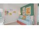 Charming bedroom featuring a cozy daybed, whimsical wall decor, and cheerful color accents at 136 Jones Fish Camp Rd, Edgewater, FL 32141