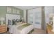 Comfortable bedroom with a stylish green accent wall, plush bedding, and ample natural light at 136 Jones Fish Camp Rd, Edgewater, FL 32141