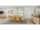 Bright dining room with stylish table, chairs, buffet, modern decor, and natural lighting at 136 Jones Fish Camp Rd, Edgewater, FL 32141