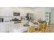 Modern kitchen with white cabinets, stainless steel appliances, large countertop, and island seating at 136 Jones Fish Camp Rd, Edgewater, FL 32141
