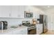 Modern kitchen with white countertops, stainless steel appliances, and abundant cabinet space at 136 Jones Fish Camp Rd, Edgewater, FL 32141
