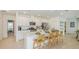 Bright kitchen with stainless steel appliances, white cabinets, and an island with barstool seating at 136 Jones Fish Camp Rd, Edgewater, FL 32141