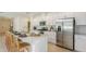 Bright, modern kitchen features a large island with seating and stainless steel appliances at 136 Jones Fish Camp Rd, Edgewater, FL 32141
