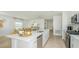 Open-concept kitchen with a large island, stainless steel appliances, and an adjacent dining area at 136 Jones Fish Camp Rd, Edgewater, FL 32141