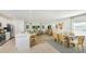 Bright open-concept living space with a modern kitchen, dining area, and comfortable living room setup at 136 Jones Fish Camp Rd, Edgewater, FL 32141