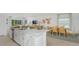 Open living space with a modern kitchen island, dining area, and stylish decor at 136 Jones Fish Camp Rd, Edgewater, FL 32141