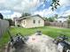 Backyard featuring lush green lawn, patio with lawn chairs and fire pit on a sunny day at 1400 Yates St, Orlando, FL 32804