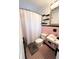 This bathroom features pink and black tiles, a shower with curtain, and a decorative mirror at 1400 Yates St, Orlando, FL 32804