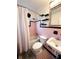 This bathroom features pink and black tiles, a shower with curtain, and a decorative mirror at 1400 Yates St, Orlando, FL 32804