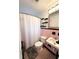 Bathroom featuring pink tiling, a shower with curtain, and decorative mirror at 1400 Yates St, Orlando, FL 32804