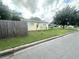 Well-maintained front yard, grassy area with a fence, street view, and a single-story house at 1400 Yates St, Orlando, FL 32804