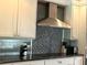 Modern kitchen with stainless steel appliances, granite countertops, and custom backsplash at 1400 Yates St, Orlando, FL 32804