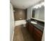 Bathroom with dark granite counters, neutral tile, and shower-tub combination at 190 Riverbend Dr # 102, Altamonte Springs, FL 32714