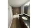 Cozy bathroom with neutral tile, dark granite countertop, and shower-tub combination at 190 Riverbend Dr # 102, Altamonte Springs, FL 32714