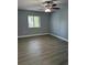 Neutral bedroom features a ceiling fan, wood-look floors, and a bright window at 190 Riverbend Dr # 102, Altamonte Springs, FL 32714