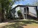 Condo exterior features include stairs, landscaped grounds, and ample trees at 190 Riverbend Dr # 102, Altamonte Springs, FL 32714