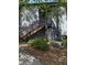 Condo exterior with stairs leading to upper unit and natural landscaping at 190 Riverbend Dr # 102, Altamonte Springs, FL 32714