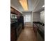 Kitchen features stainless appliances, dark counters, tile flooring, and wood cabinets at 190 Riverbend Dr # 102, Altamonte Springs, FL 32714