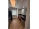 Compact kitchen with stainless steel dishwasher, tile floor, and wood cabinetry at 190 Riverbend Dr # 102, Altamonte Springs, FL 32714