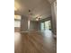 Spacious living room featuring laminate floors, a ceiling fan, and a sliding glass door at 190 Riverbend Dr # 102, Altamonte Springs, FL 32714