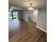 Bright living room with wood flooring, ceiling fan, and sliding glass doors leading to lanai at 190 Riverbend Dr # 102, Altamonte Springs, FL 32714