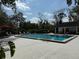Community pool area featuring ample seating and mature landscaping at 190 Riverbend Dr # 102, Altamonte Springs, FL 32714