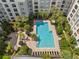 Aerial view of a rectangular pool surrounded by lounge chairs and lush landscaping at 206 E South St # 6007, Orlando, FL 32801