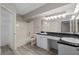 Bathroom featuring double vanity with black countertop and a shower-tub combination at 206 E South St # 6007, Orlando, FL 32801